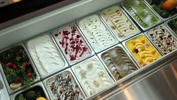 A variety of ice cream flavors in a metal container.