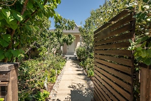 Stroll through lush gardens to a charming building with a simple, modern design.