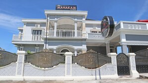 A large, two-story building with a sign reading "MAHAKAM Guest House." - OYO 1326 Mahakam Guest House (Padang)