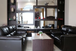 Relax in this stylish living room with two sofas, a coffee table, and shelving.