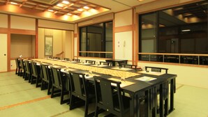 A conference room with a long table, chairs, and a large window. - Yasuragiso (Joetsu)
