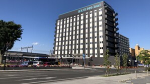 A multi-story hotel with a modern design, featuring a prominent sign at the top. - Hotel Route-Inn Grand Ota Ekimae (Ota)