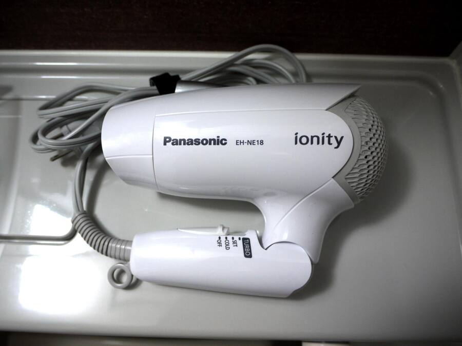 A Panasonic ionity hair dryer with a cord and a power switch.
