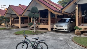 A row of traditional-style buildings with a car parked in front. - Sukthawee (Prachuap Khiri Khan)