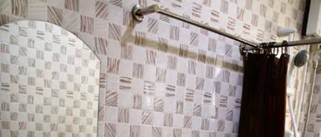 A bathroom with a sink, toilet, and shower curtain.