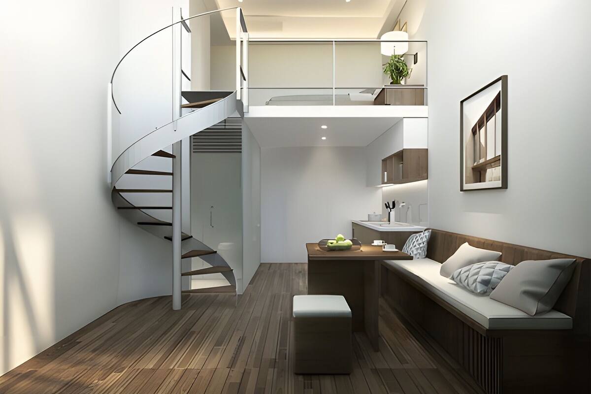 Un interior moderno con una escalera de caracol, suelo de madera, un sofá, una mesita y una zona de cocina.