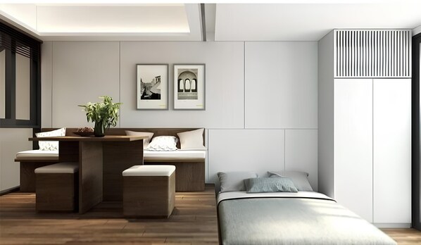 Une chambre moderne avec un lit, des tables de chevet, un bureau et une plante en pot.