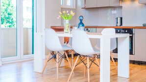 A modern kitchen with white cabinets, a wooden countertop, and a built-in oven. - Apartment Franco (Split)