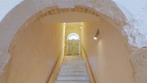A staircase with a wooden handrail leading to a door at the top. - Historic Piazza House & Romantic Garden (Hvar)