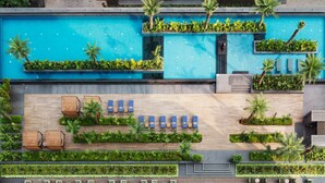 A modern hotel with a rooftop pool, outdoor seating areas, and lush landscaping. - The Ritz-Carlton, Pune (Pune)