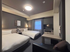 A hotel room with two beds, a desk, a flat-screen TV, and a window with curtains. - Hotel Route-Inn Masuda (Masuda)