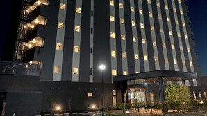 A multi-story hotel with a prominent neon sign reading "HOTEL ROUTE INN".