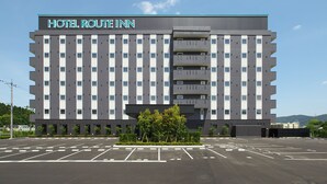 A large hotel building with a sign reading "HOTEL ROUTE INN" and a parking lot in front. - Hotel Route-Inn Takefu Inter (Echizen)