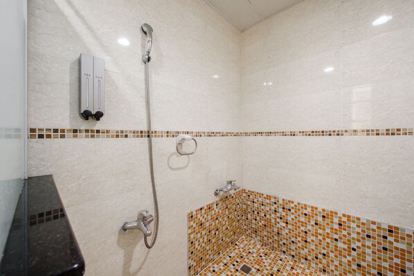 Un baño con ducha, inodoro y lavamanos.