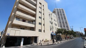 A multi-story building with a flat facade, a ground-level entrance, and a visible staircase leading to the upper floors. - Gabriel Apartments - Stylish Suites - King George ST (Jerusalem)