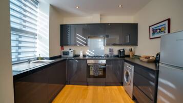 Deluxe Apartment, 2 Bedrooms | Private kitchen | Full-size fridge, microwave, oven, stovetop