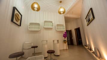 Experience the sleek, modern reception area with a counter, seating, and unique geometric ceiling.