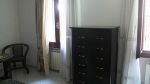 A room with a radiator, a chair, and a tall black cabinet. - Venezianamente-Casa della Crea Canal (Venice)