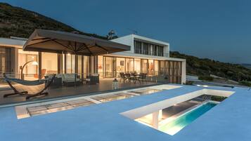 Seasonal outdoor pool, an infinity pool, pool loungers