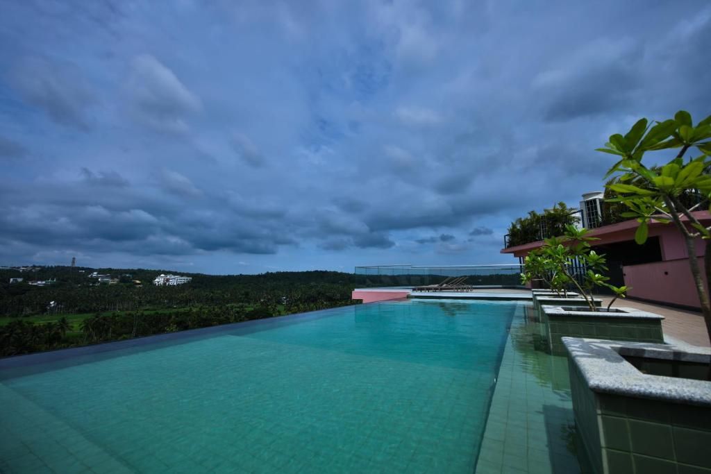 A swimming pool with a view of a hill and a building in the distance.