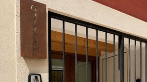 A gated entrance to a building with a sign reading 'GALLERY' and a security keypad.