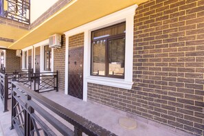 Traditional building with a brick facade and metal railing.