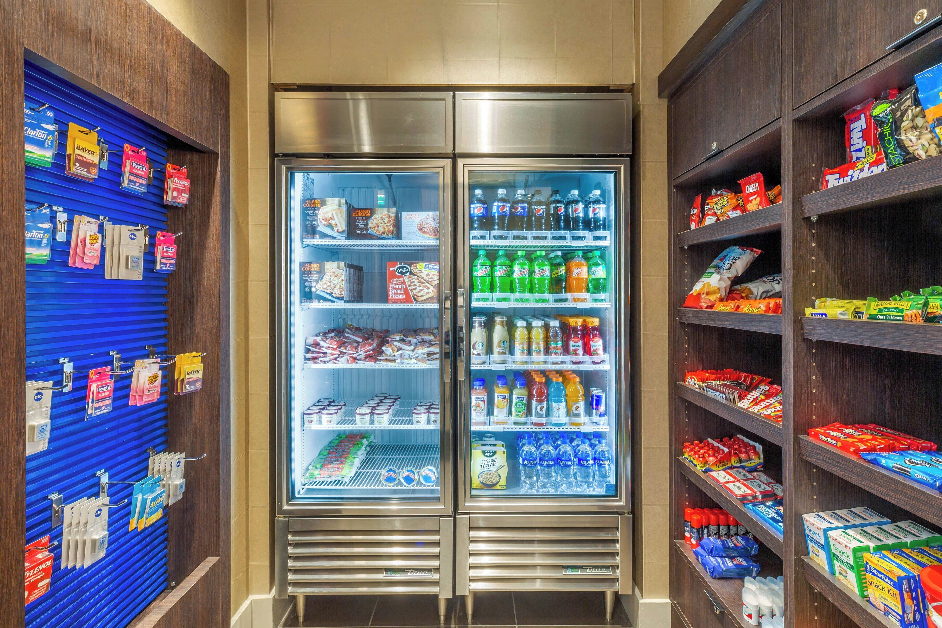 A refrigerated display case with snacks and bottled beverages.