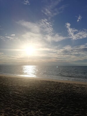 Experience the serene tranquility of a secluded beach at sunset.