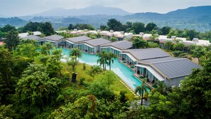 A resort with multiple buildings, a central swimming pool, and lush greenery. - The Forest Club Resort (Karjat)