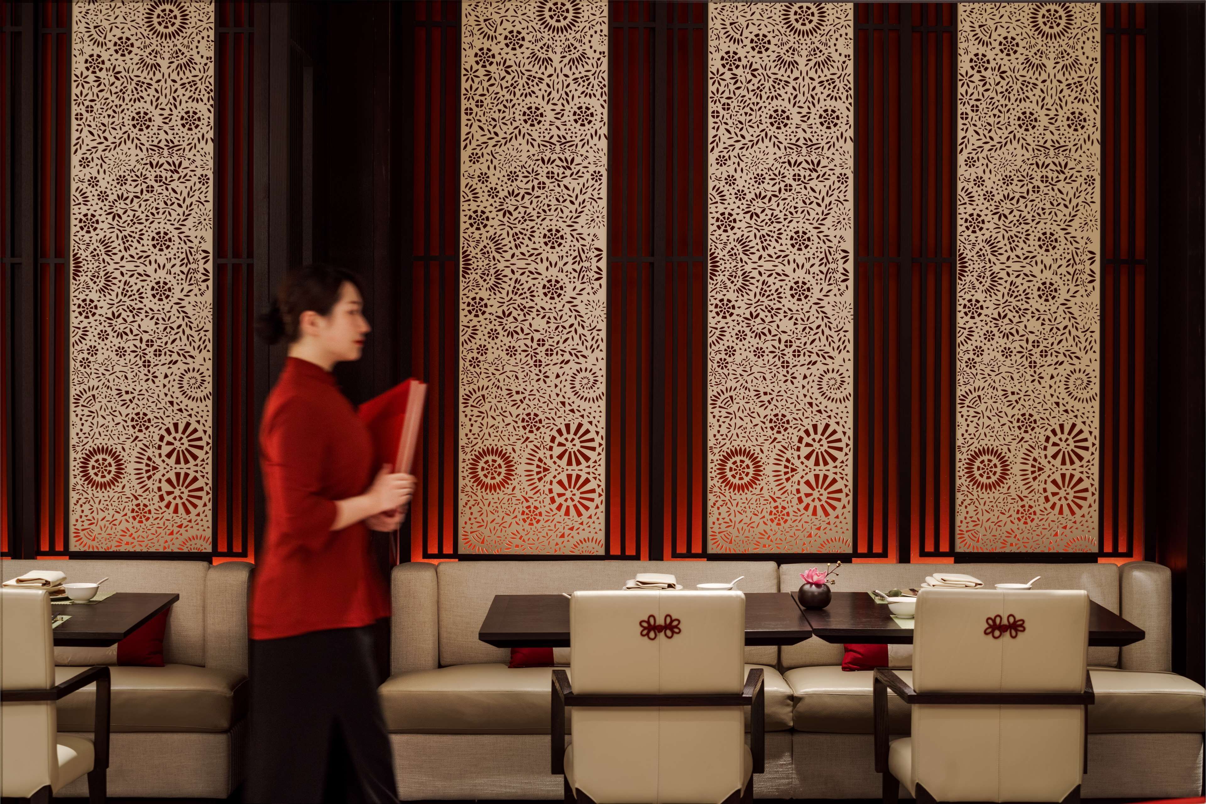 A modern interior with a sofa, dining table, and chairs.