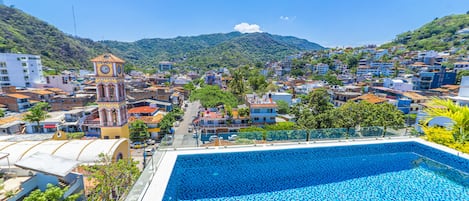 Outdoor pool, open 7:00 AM to 10:00 PM, pool umbrellas, sun loungers