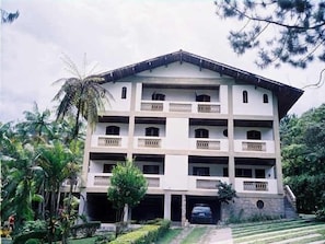 Stunning multi-story building with a central entrance and beautifully landscaped surroundings.