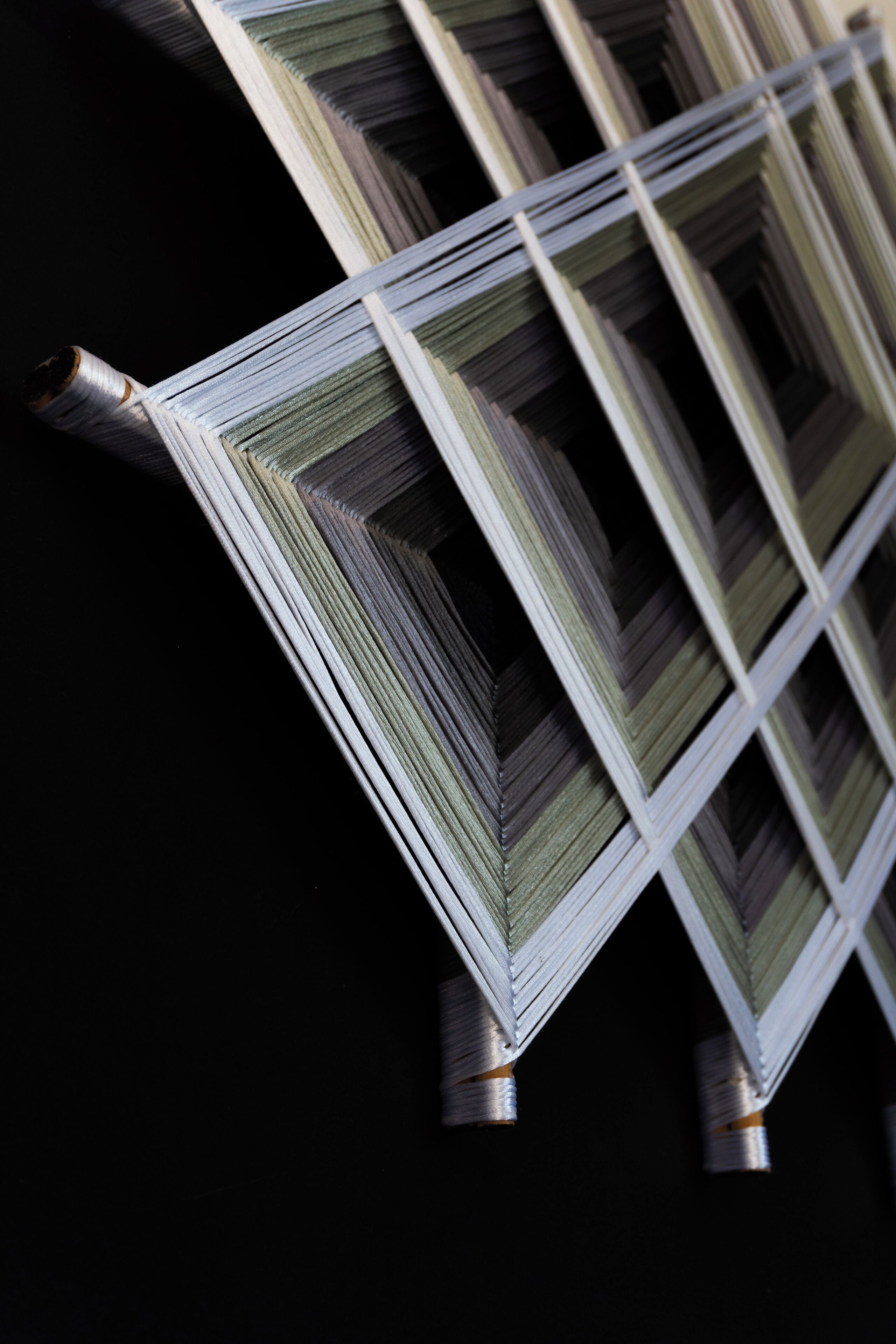 A close-up of stacked books or documents with a dark background.