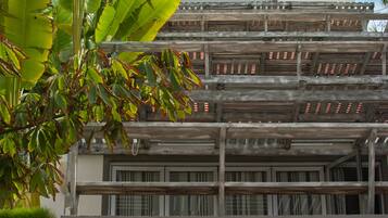 A multi-story building with a modern architectural design, featuring balconies and large windows.