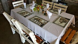 Une table à manger dressée avec une nappe blanche, des serviettes et un centre de table.