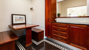 A kitchen with wooden cabinets, a countertop, and a tiled floor. - Lighthouse Cozy 2BDR with CITY VIEWS (Middle Park)