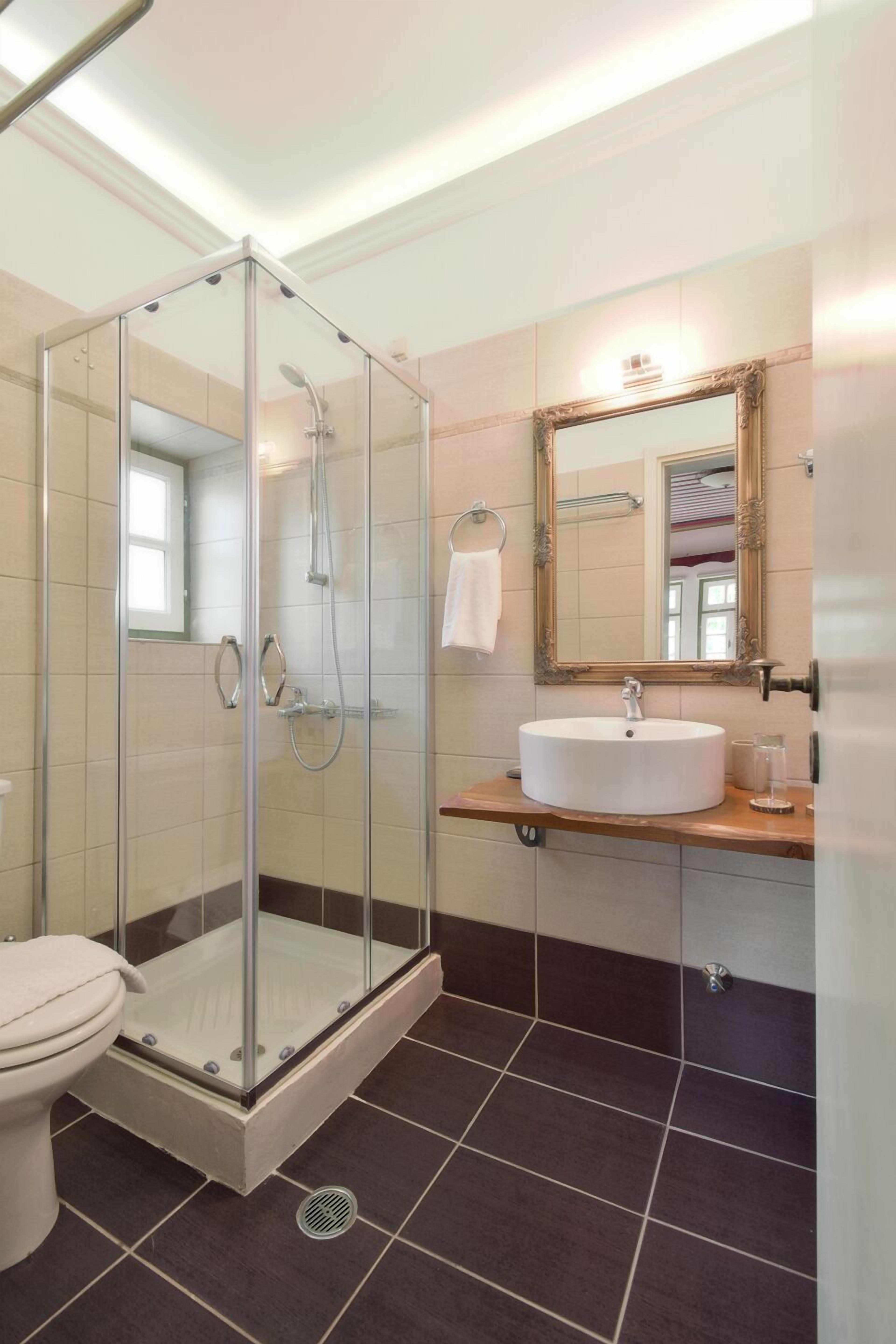 designer toiletries, hair dryer, slippers, towels