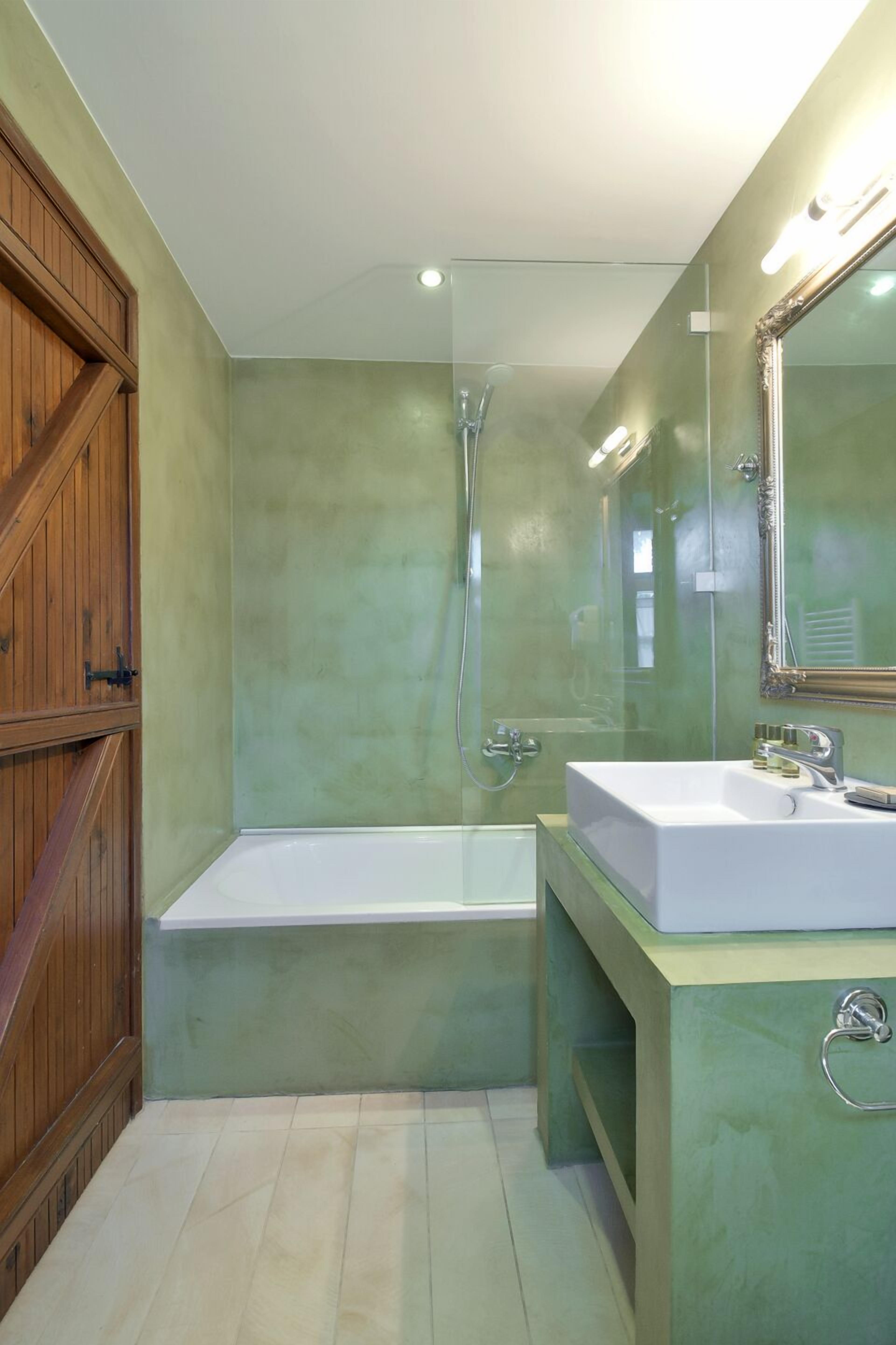 A bathroom with a bathtub, a sink, and a shower.