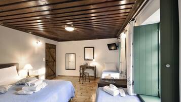 Deluxe Triple Room | Minibar, individually decorated, desk, blackout curtains