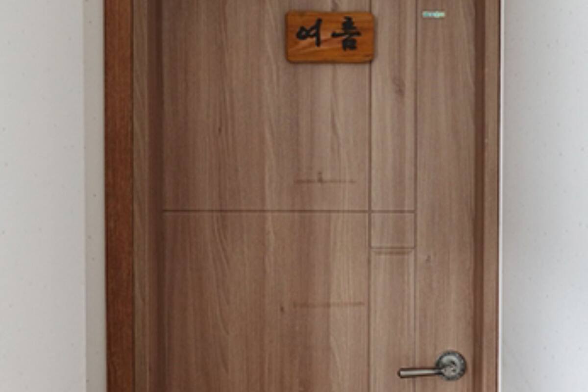 A wooden door with a sign above it.