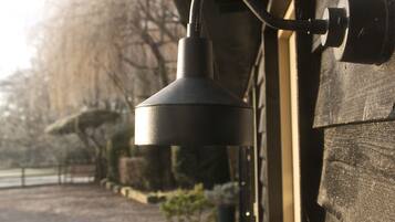 A close-up of a lamp attached to a wooden wall.