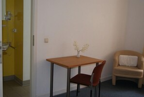 Singola Comfort, bagno privato | Area soggiorno | TV