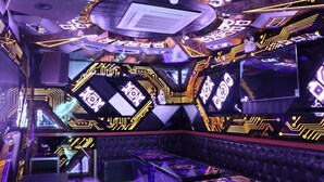 A room with a futuristic design, featuring hexagonal patterns and neon lights. - Nha hang & Khach San Tay Bac (Tuan Giao)