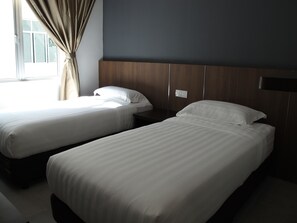 Twin Room | Desk, laptop workspace, blackout curtains, iron/ironing board - Hotel Sukaramai (Gurun)