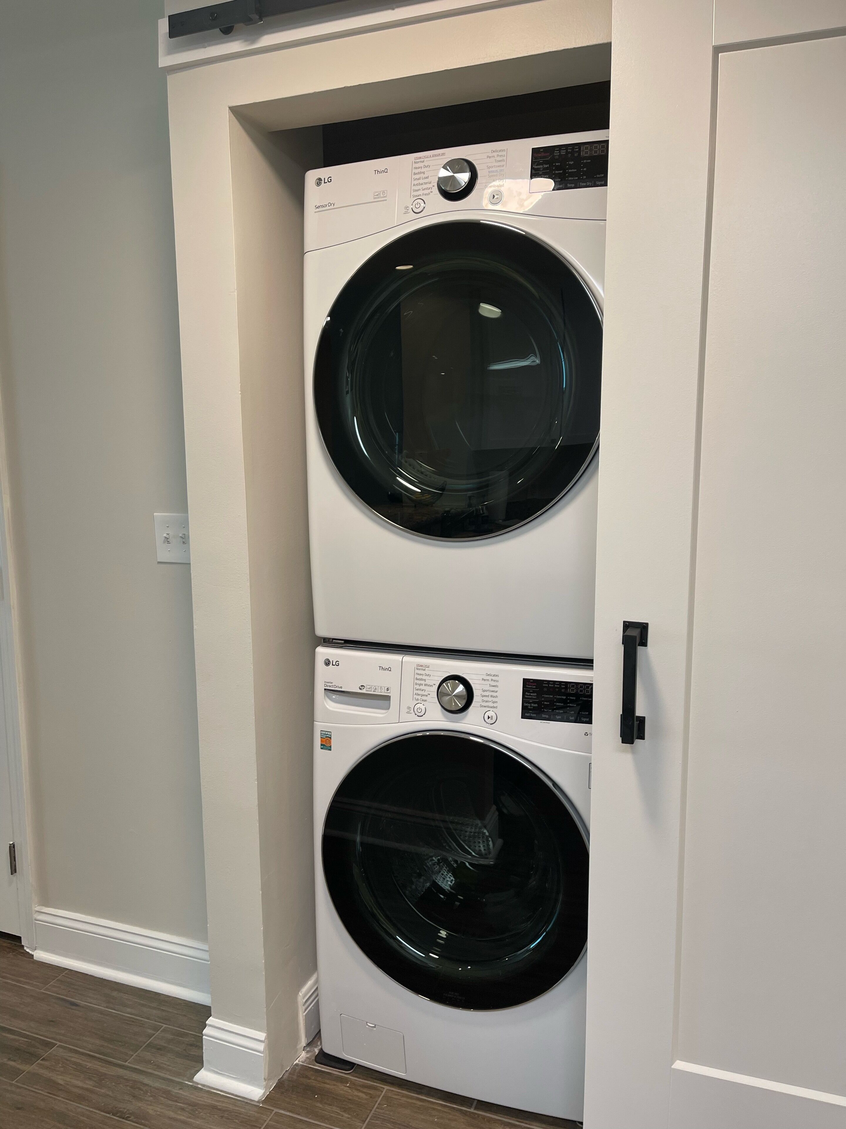 A laundry room with two stacked front-loading washing machines.