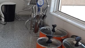 A kitchen with granite countertops, a sink, and a window with a view of the outside. - Riverland Apartments (Nairobi)