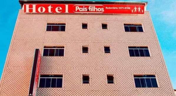A hotel building with a tiled facade and multiple windows.