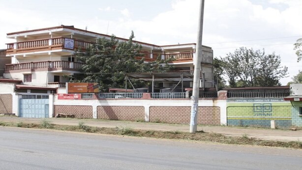 A multi-story building with balconies, a gated entrance, and a sign for a hotel. - Salmond View Hotel (Bungoma)