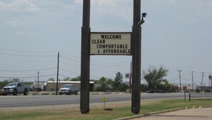 A motel sign with the name 'RIDGE MOTEL' and a welcoming message.