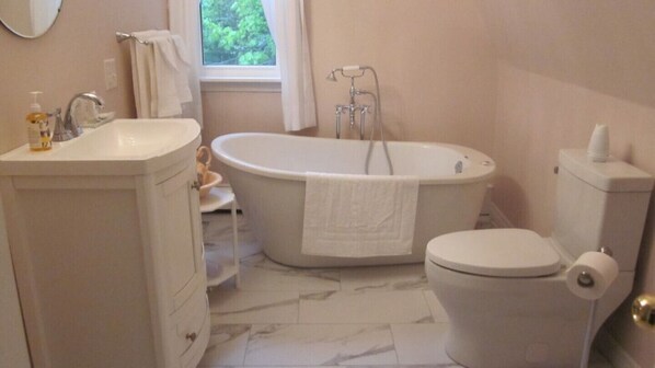 A bathroom with a bathtub, toilet, and sink. - Chestnut Lane Bed & Breakfast - The Rose Room (New Glasgow)